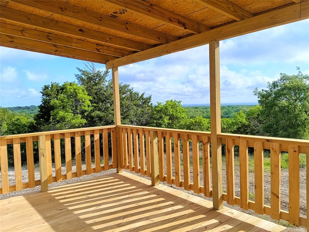 700 Woodhaven Drive Springtown, TX 76082 - Photo 1 of 15 a view of a wooden deck