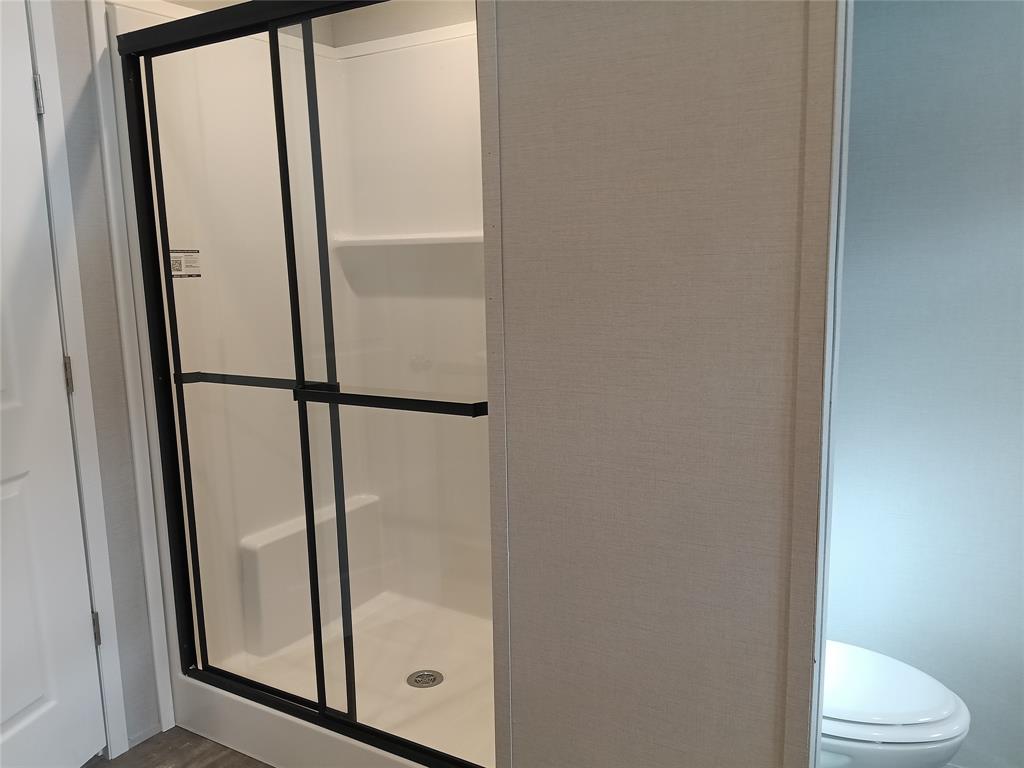 700 Woodhaven Drive Springtown, TX 76082 - Photo 14 of 15 a bathroom with a glass door shower