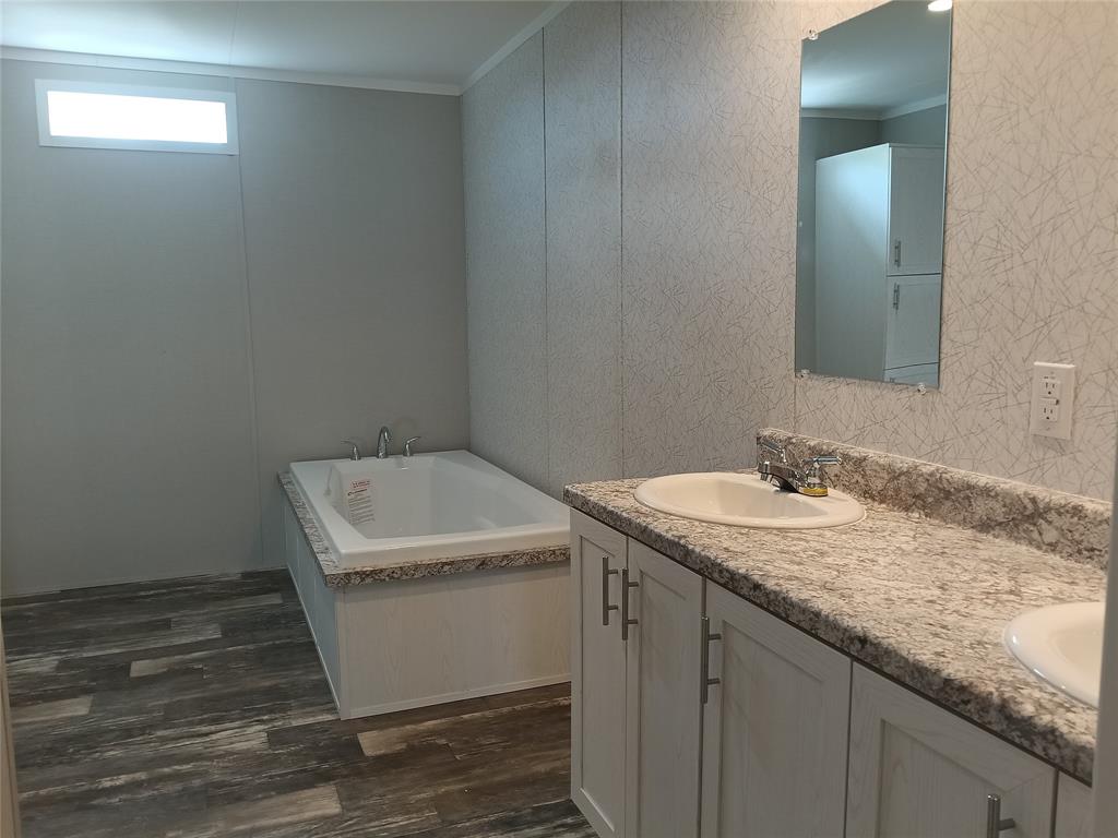 700 Woodhaven Drive Springtown, TX 76082 - Photo 15 of 15 a bathroom with a granite countertop sink and mirror