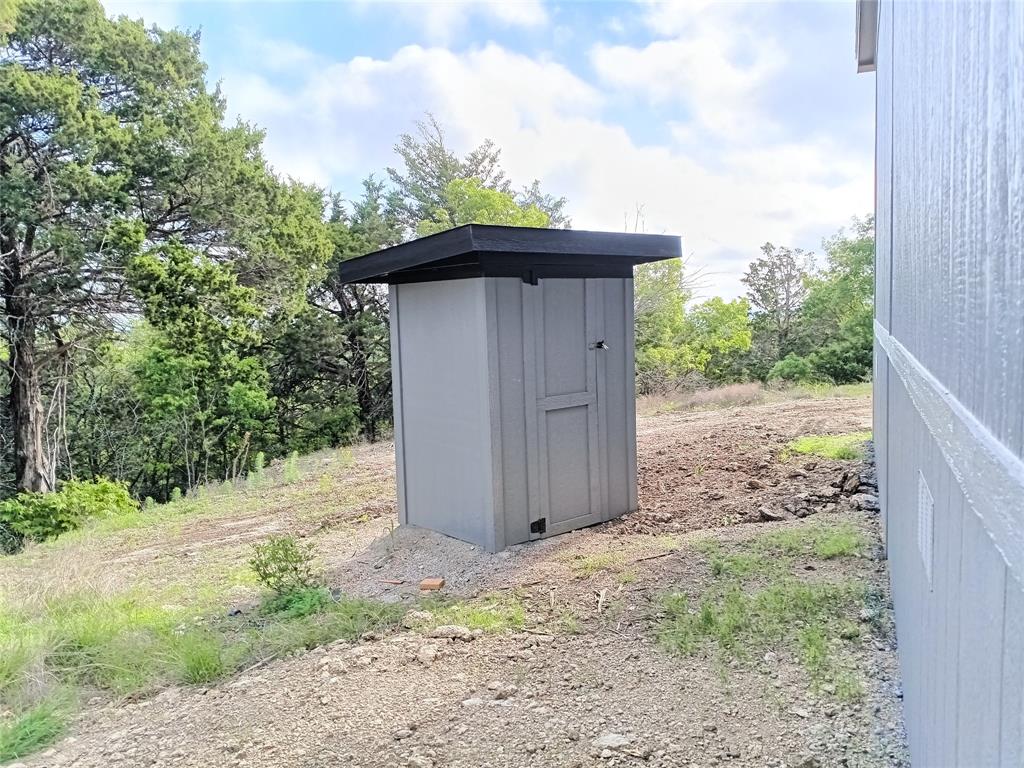 700 Woodhaven Drive Springtown, TX 76082 - Photo 9 of 15 a view of a wooden door and a yard