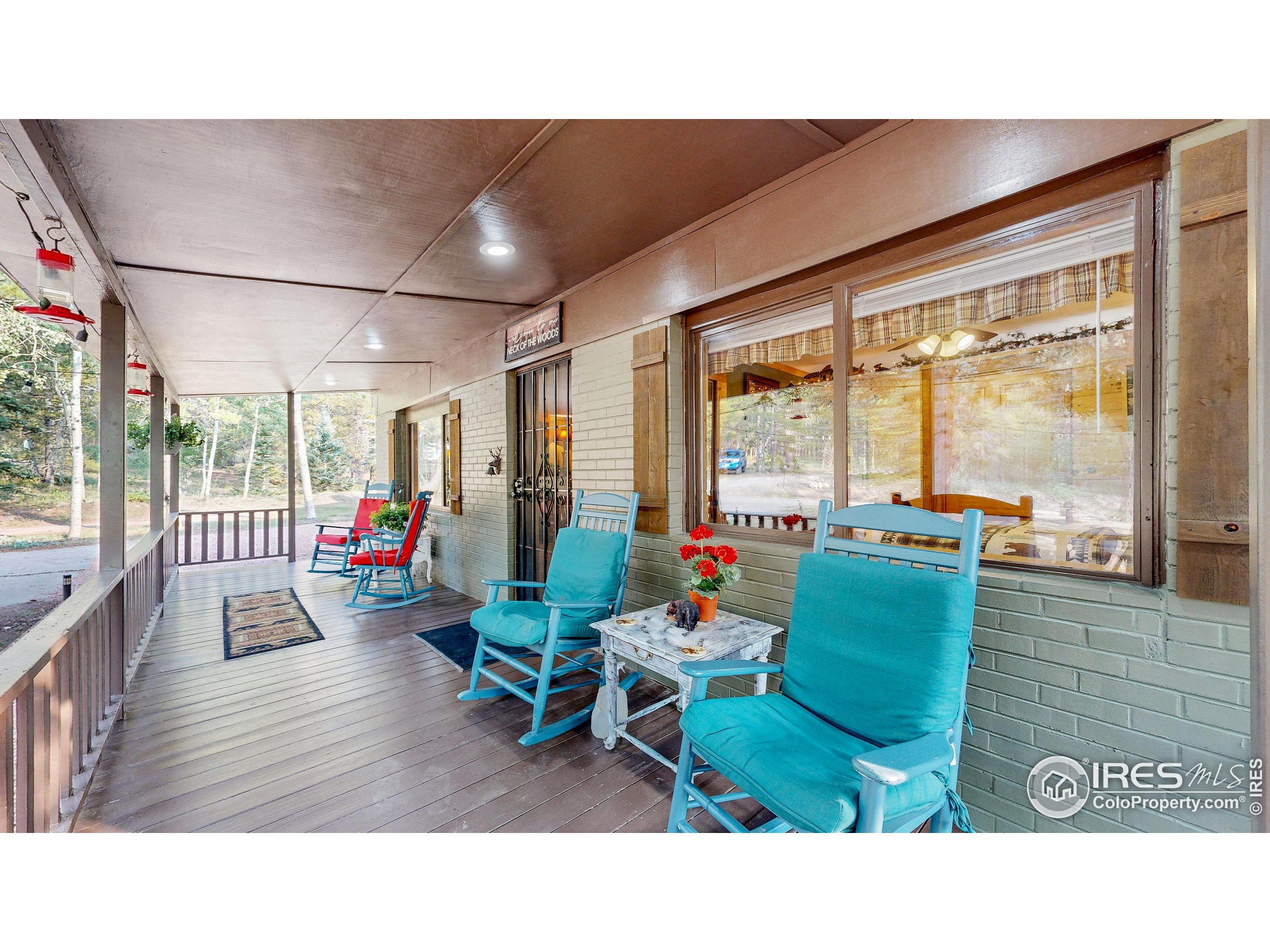 2420 Big Owl Road Allenspark, CO 80510 - Photo 24 of 40 a living room with furniture and a large window