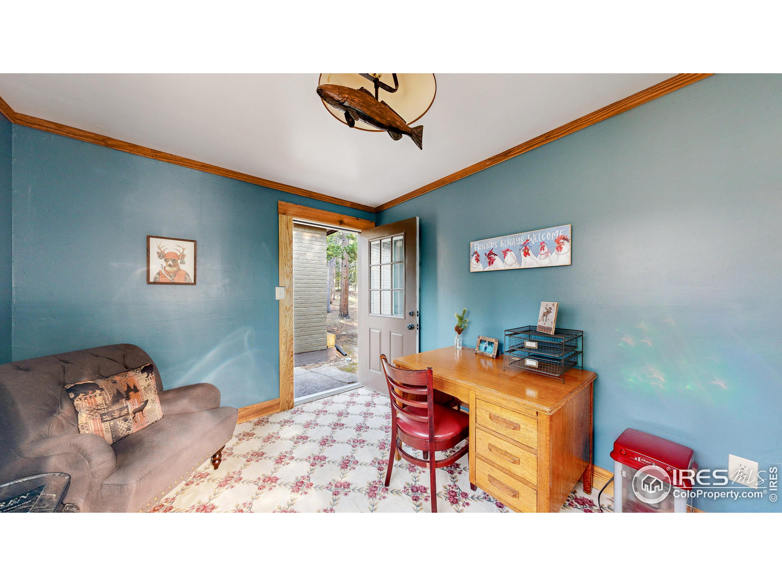 2420 Big Owl Road Allenspark, CO 80510 - Photo 30 of 40 a bedroom with a bed and a chandelier