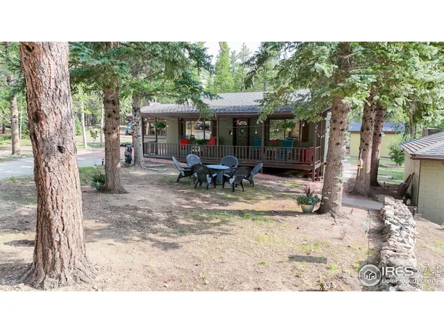 a backyard of a house with fire pit and outdoor seating