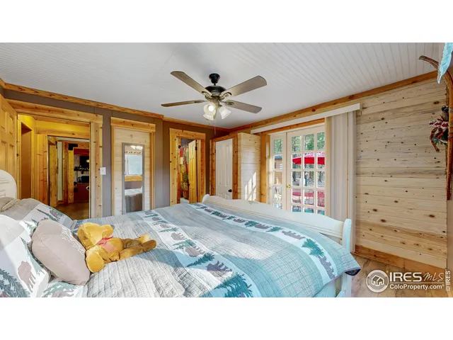 a bedroom with a bed and a ceiling fan