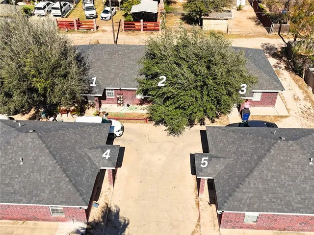 an aerial view of residential houses with outdoor space