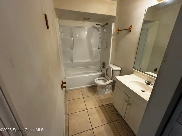 a bathroom with a toilet a sink and shower