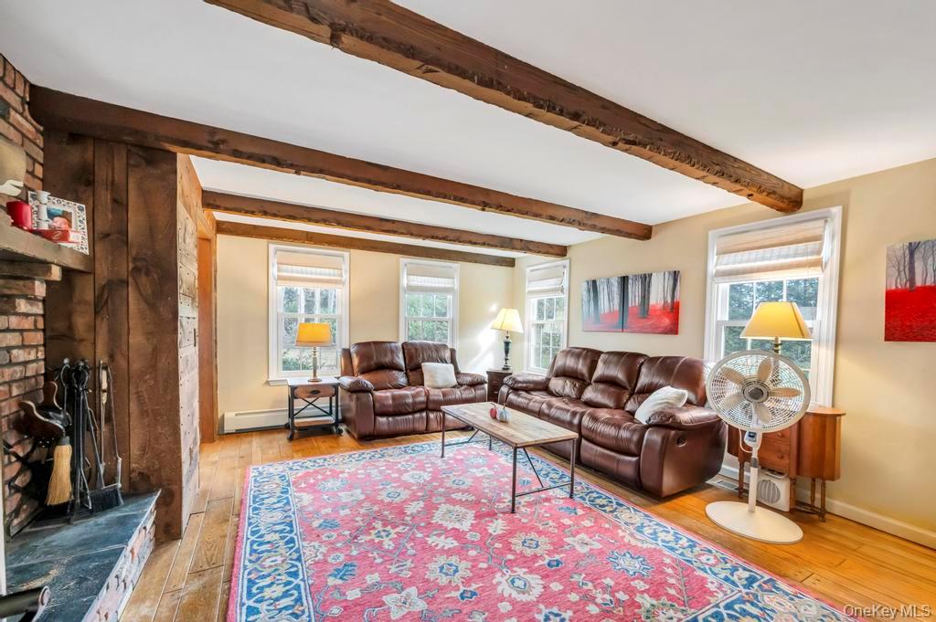 807 Union Avenue Riverhead, NY 11901 - Photo 11 of 41 a living room with furniture wooden floor and a table