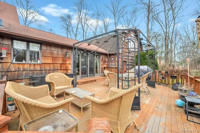 a view of a patio with table and chairs and wooden floor