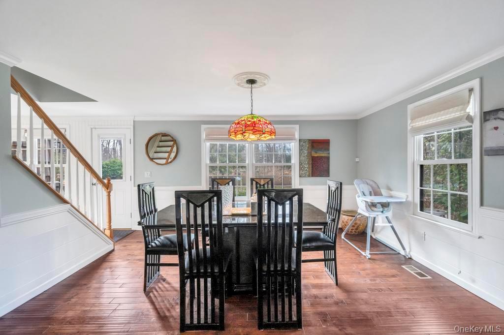 807 Union Avenue Riverhead, NY 11901 - Photo 12 of 41 a view of a dining room with furniture window and wooden floor