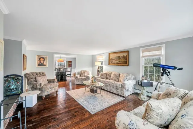 a living room with furniture rug and wooden floor