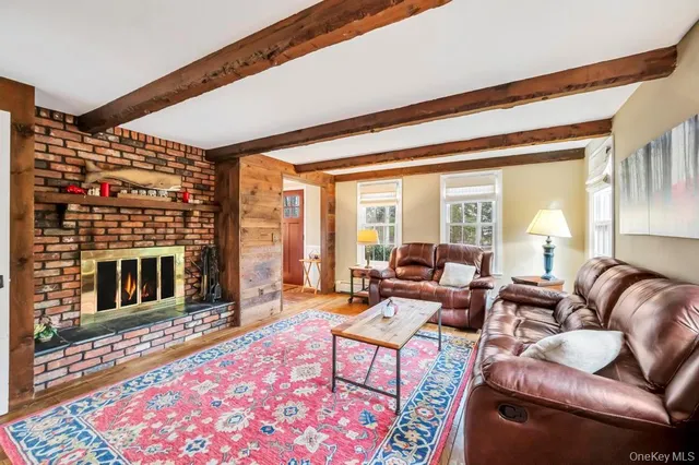a living room with furniture a rug and a fireplace