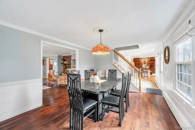 a view of a dining room with furniture wooden floor and chandelier