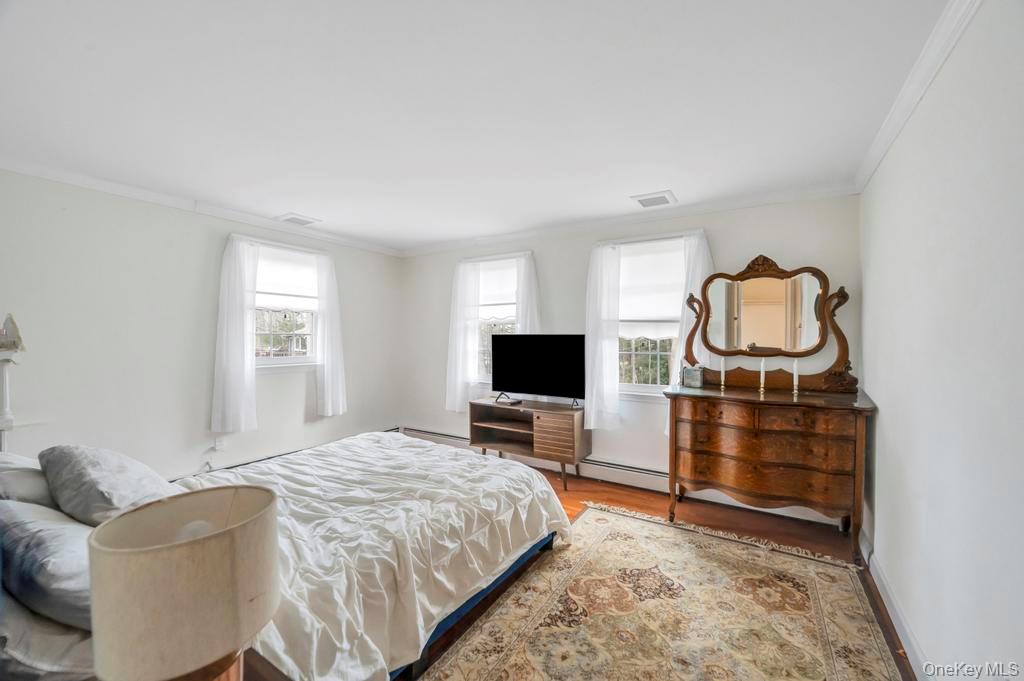 807 Union Avenue Riverhead, NY 11901 - Photo 23 of 41 a bedroom with a bed and flat screen tv