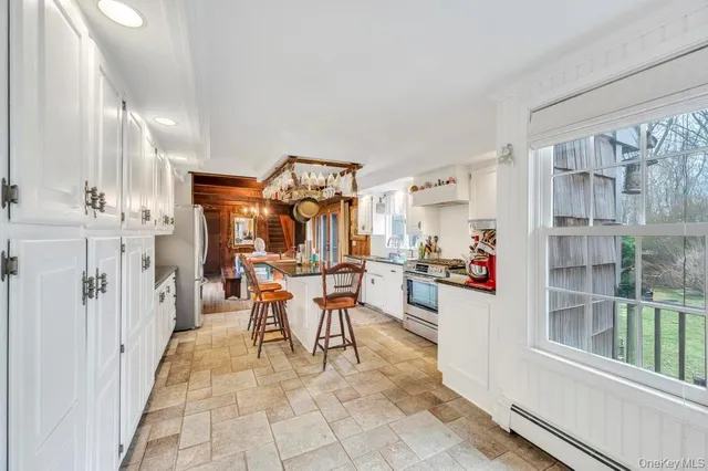 a kitchen with stainless steel appliances granite countertop a sink and a refrigerator