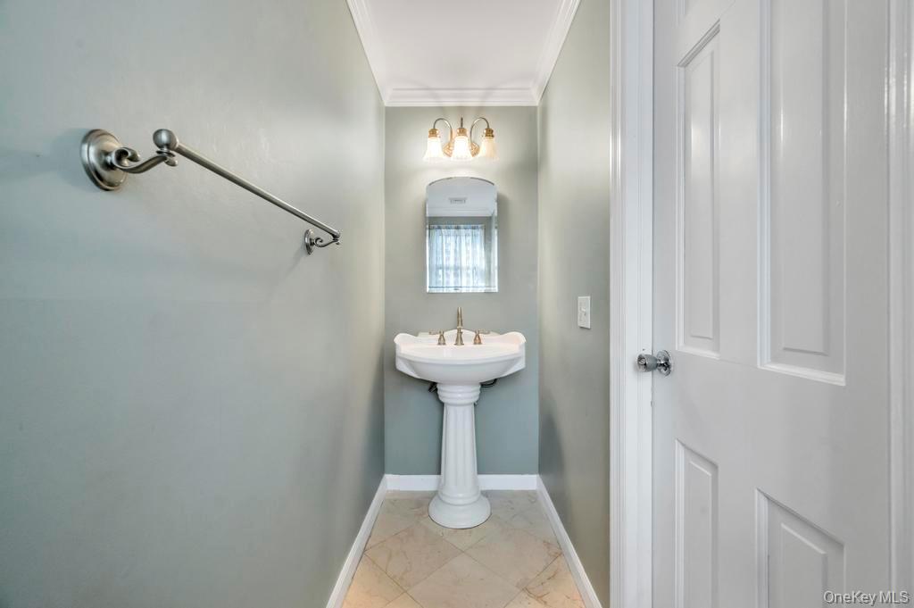 807 Union Avenue Riverhead, NY 11901 - Photo 28 of 41 a bathroom with a sink a mirror and shower view