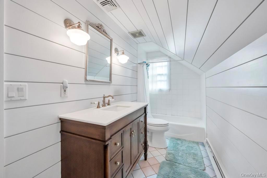 807 Union Avenue Riverhead, NY 11901 - Photo 29 of 41 a bathroom with a sink a toilet and large mirror