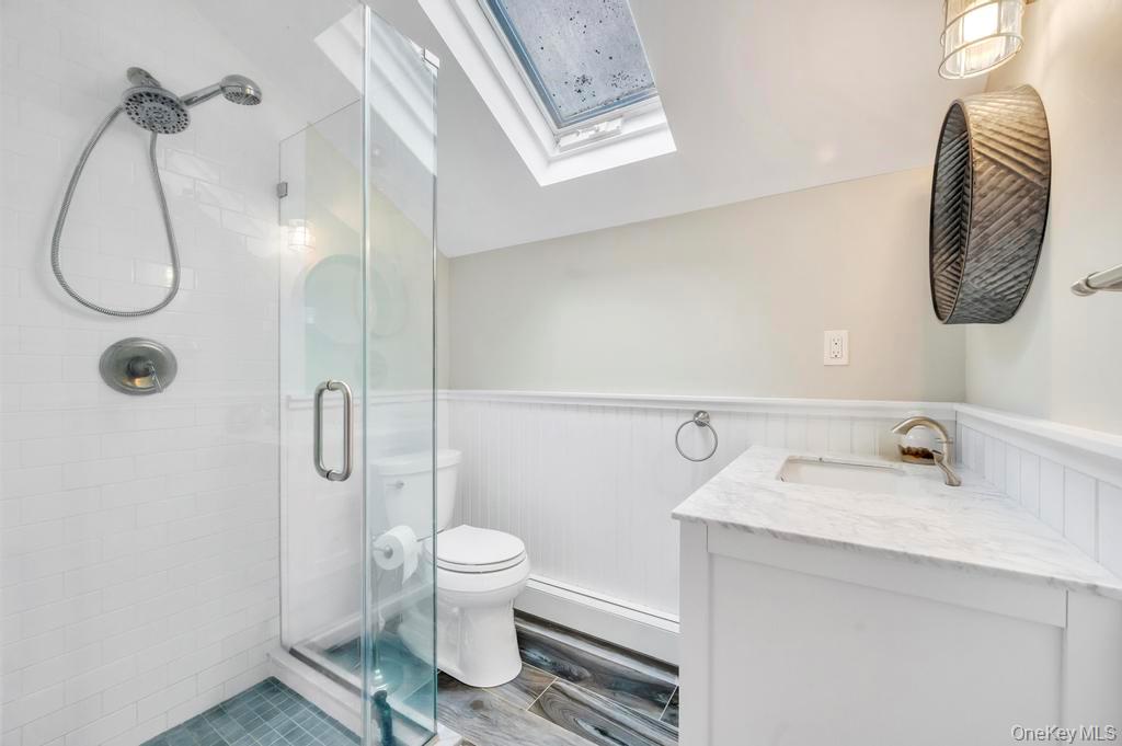 807 Union Avenue Riverhead, NY 11901 - Photo 32 of 41 a bathroom with a toilet sink and mirror