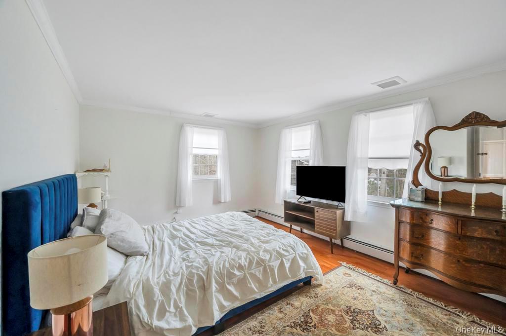 807 Union Avenue Riverhead, NY 11901 - Photo 34 of 43 a bedroom with a bed a table and chair