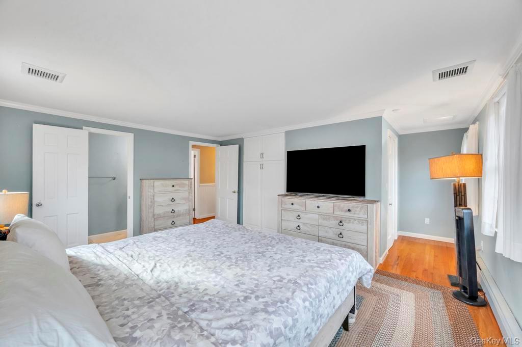 807 Union Avenue Riverhead, NY 11901 - Photo 36 of 43 a bedroom with a bed and a flat screen tv