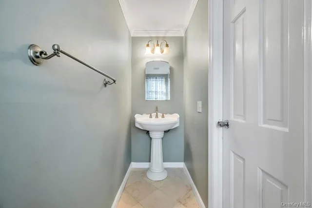 a bathroom with a sink a toilet and large mirror