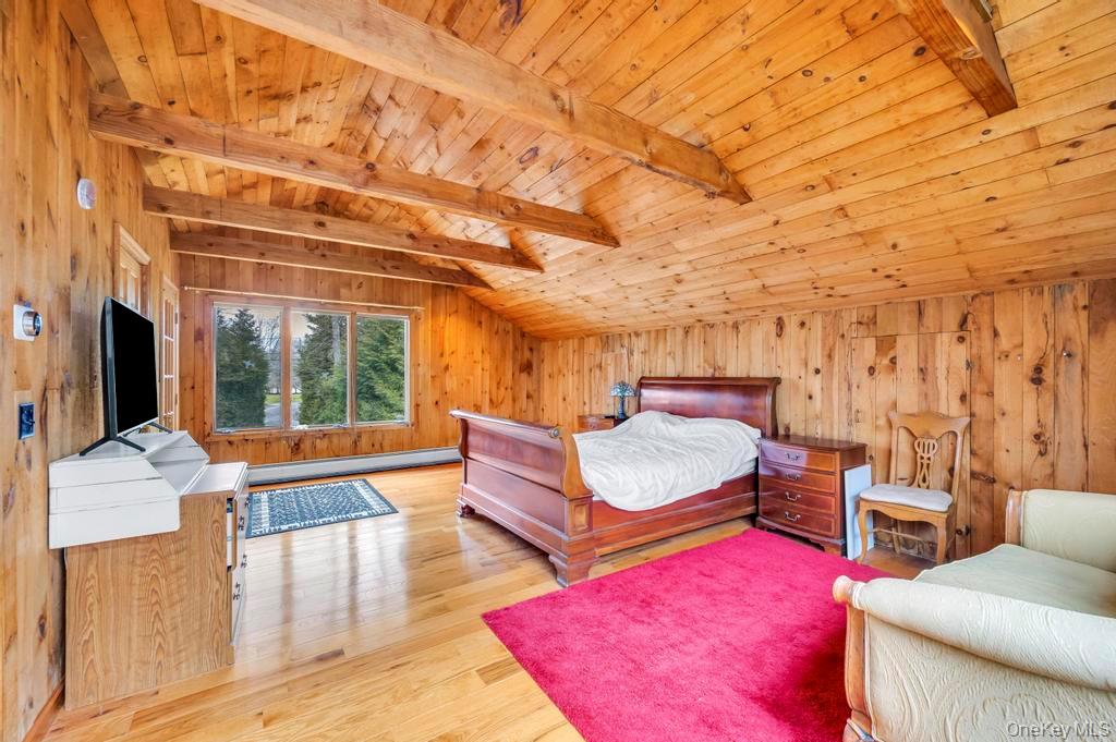 807 Union Avenue Riverhead, NY 11901 - Photo 40 of 43 a bedroom with furniture and a flat screen tv