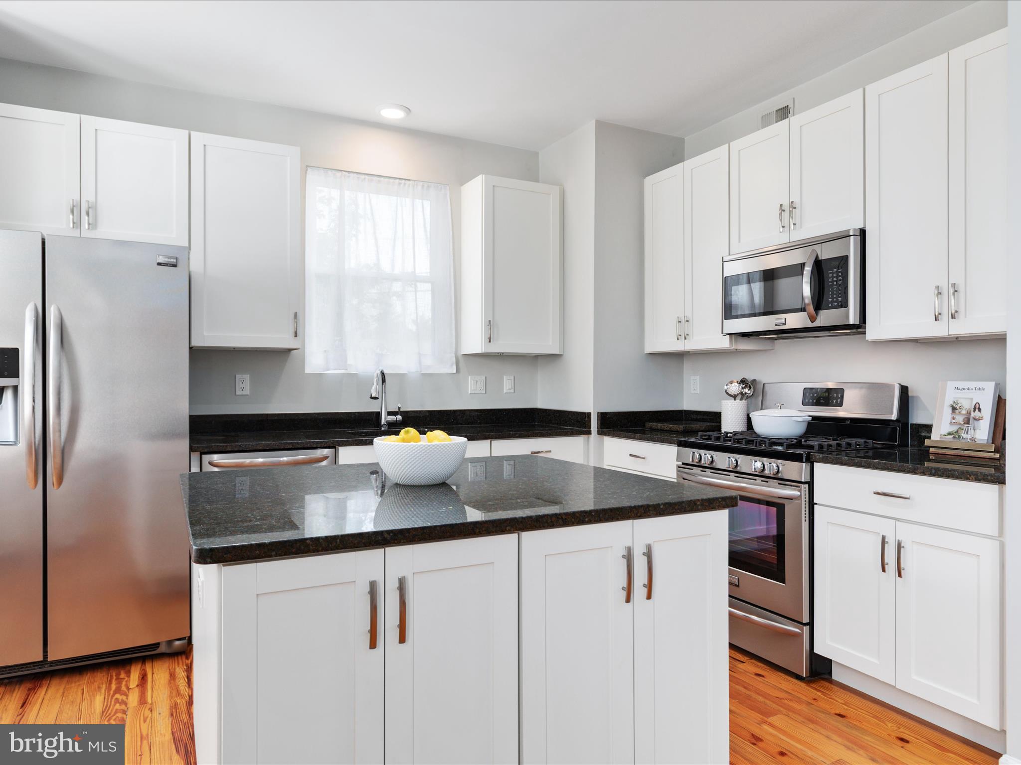 772 3rd Street Herndon, VA 20170 - Photo 11 of 52 a kitchen with stainless steel appliances granite countertop a sink stove and refrigerator