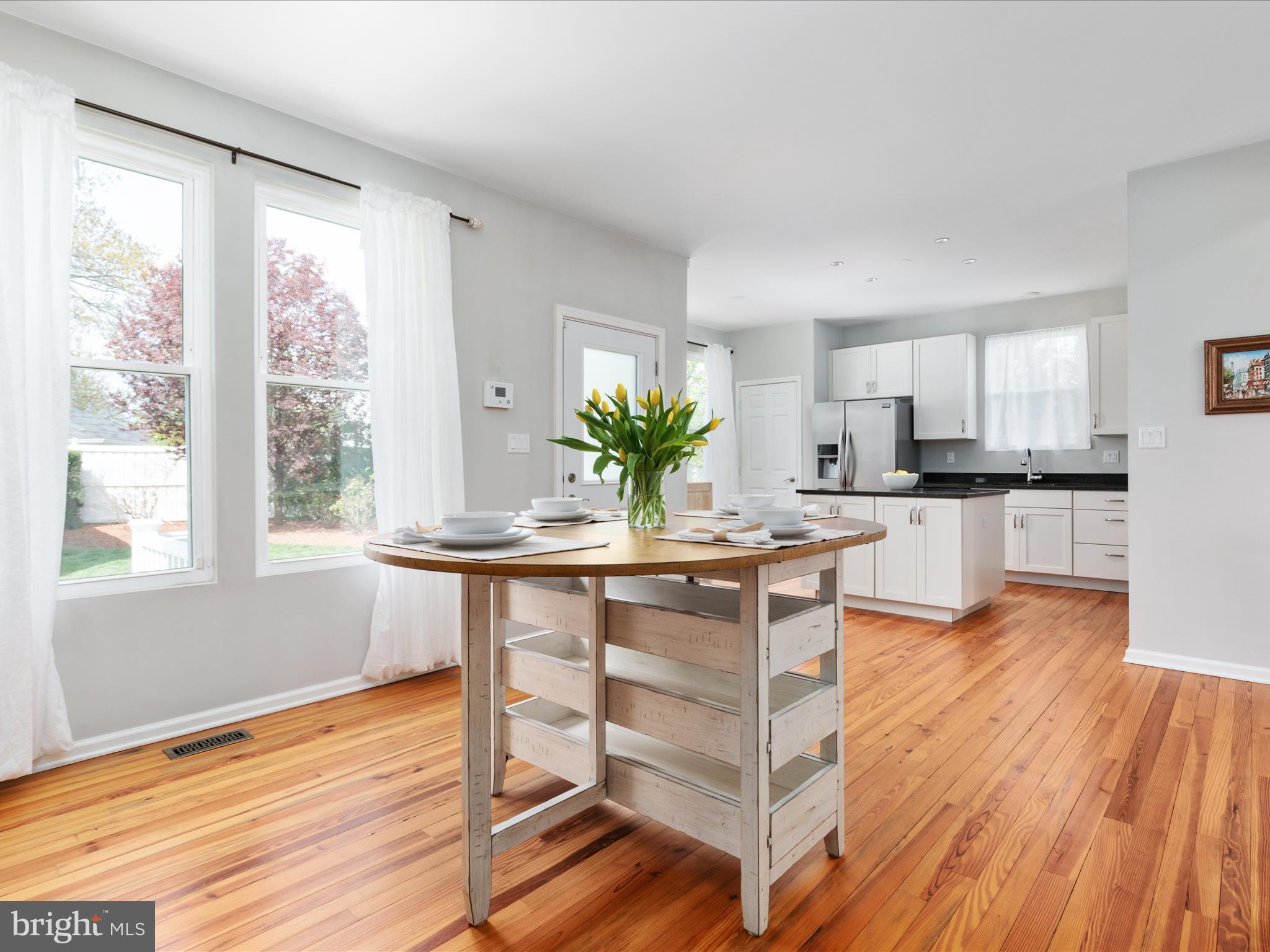 772 3rd Street Herndon, VA 20170 - Photo 12 of 52 a kitchen with stainless steel appliances granite countertop wooden floor sink and cabinets
