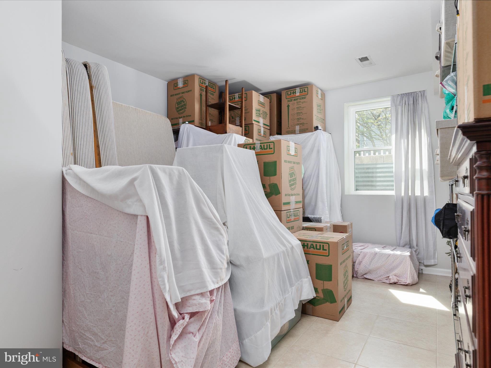 772 3rd Street Herndon, VA 20170 - Photo 30 of 52 a bed room with a bed and a book shelf