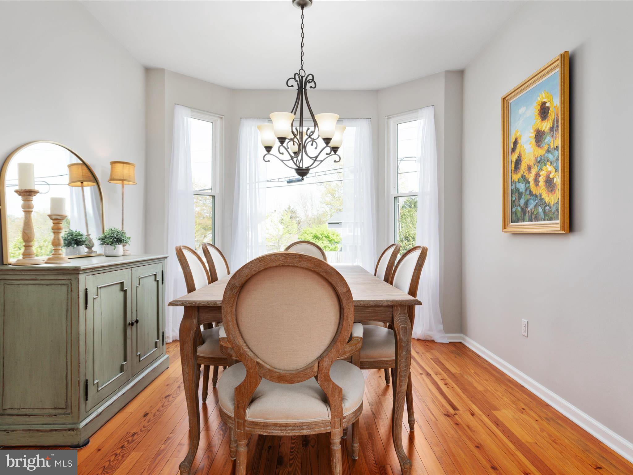 772 3rd Street Herndon, VA 20170 - Photo 8 of 52 a dining room with furniture a rug a potted plant and a chandelier