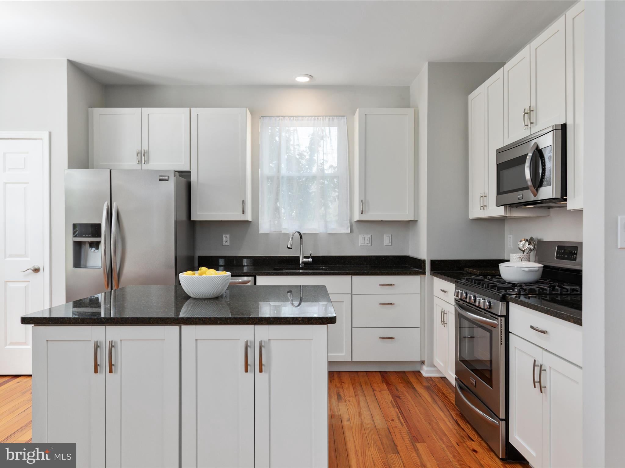 772 3rd Street Herndon, VA 20170 - Photo 10 of 52 a kitchen with stainless steel appliances granite countertop a refrigerator a stove a sink dishwasher and white cabinets with wooden floor