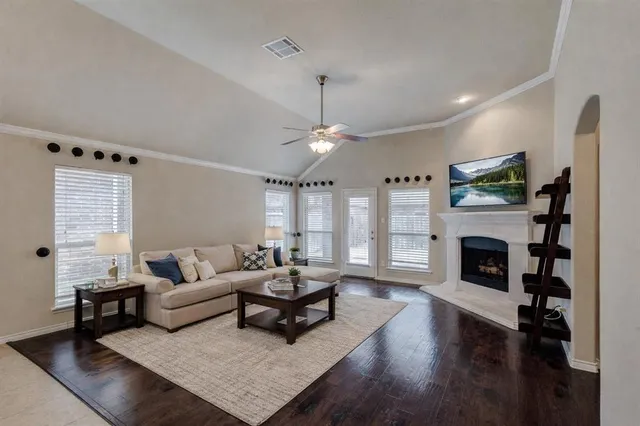 a living room with furniture a fireplace and a flat screen tv