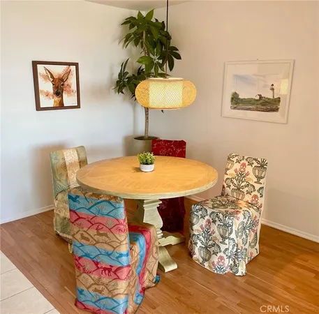 a dining room with furniture and wooden floor