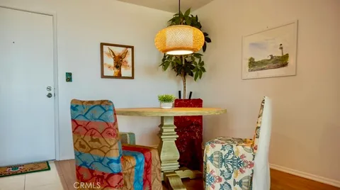 a living room with furniture and potted plants