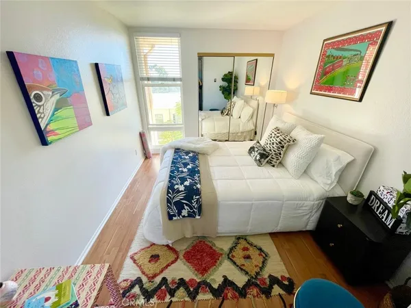 a bedroom with a bed and a painting on the wall