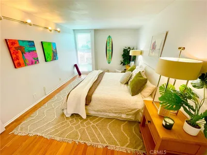 a bedroom with a bed and a painting on the wall