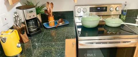 a living room with a stove and a wooden floor