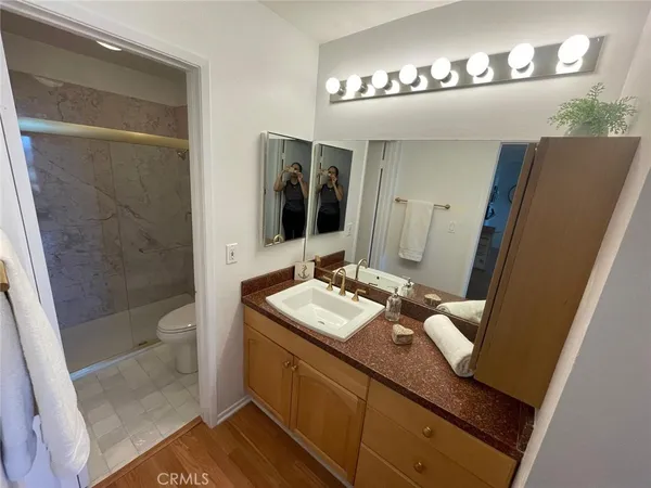 a bathroom with a sink a toilet and a mirror