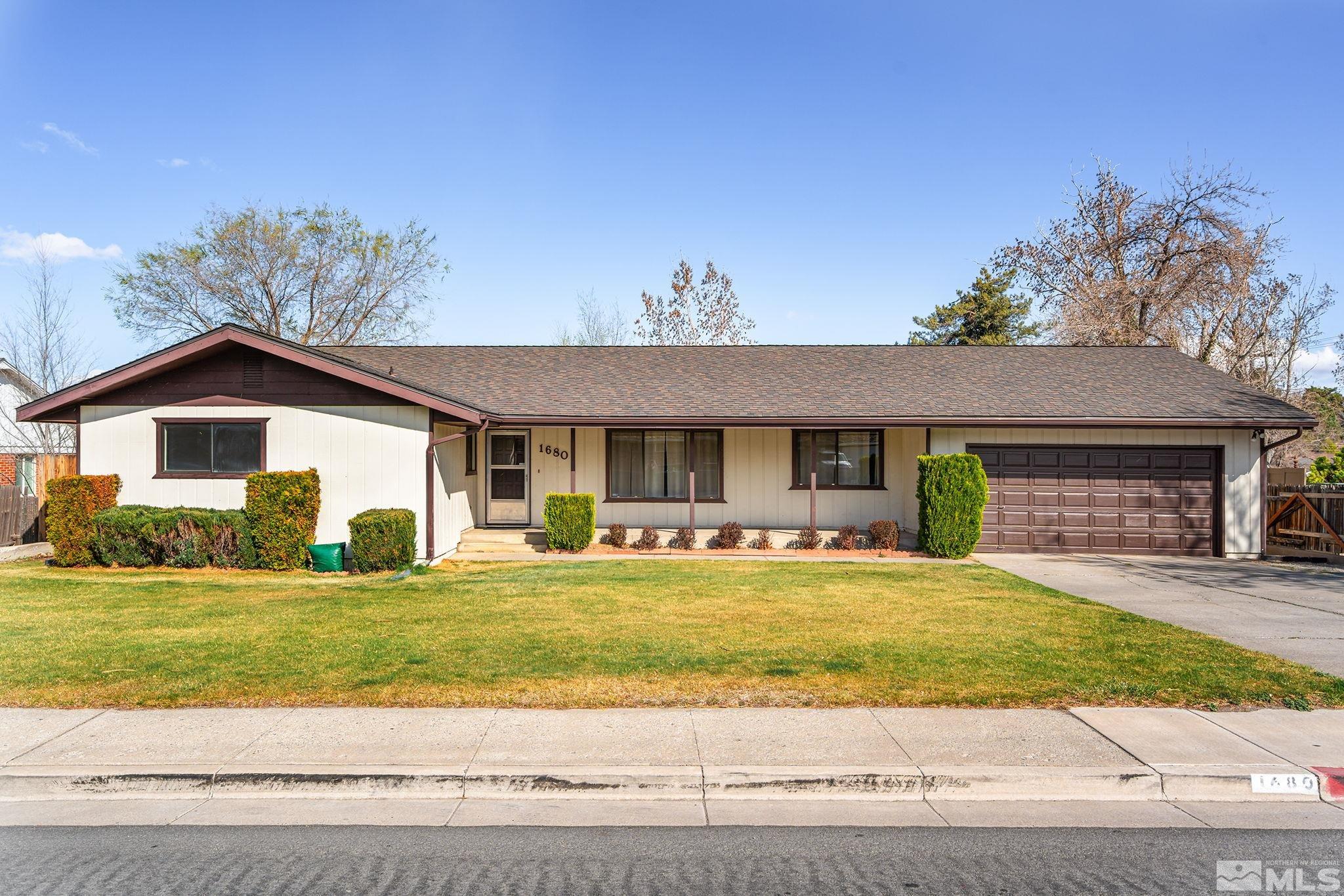 a view of a house with swimming pool and a yard
