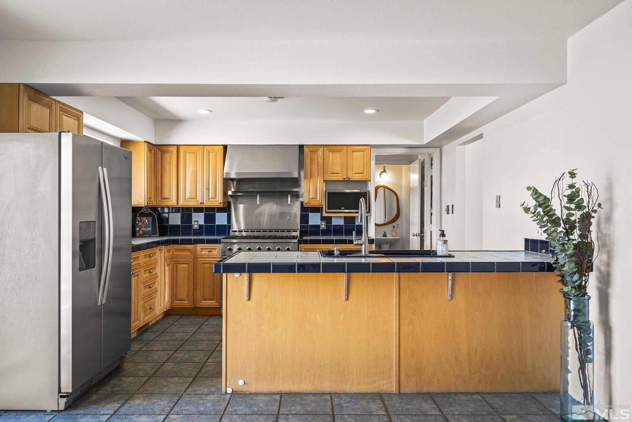 1680 Hunter Lake Drive Reno, NV 89509 - Photo 12 of 26 a large kitchen with a window a refrigerator and a sink