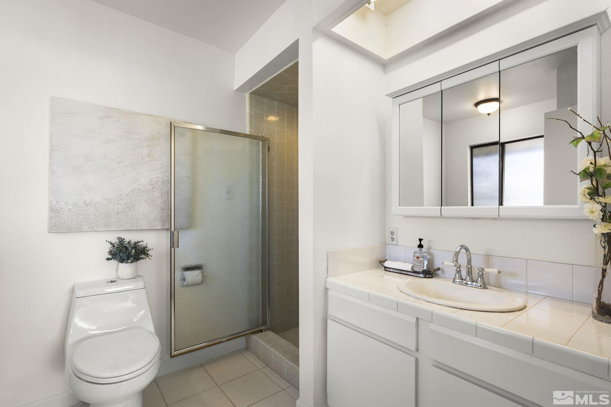 1680 Hunter Lake Drive Reno, NV 89509 - Photo 15 of 26 a bathroom with a sink a toilet and shower