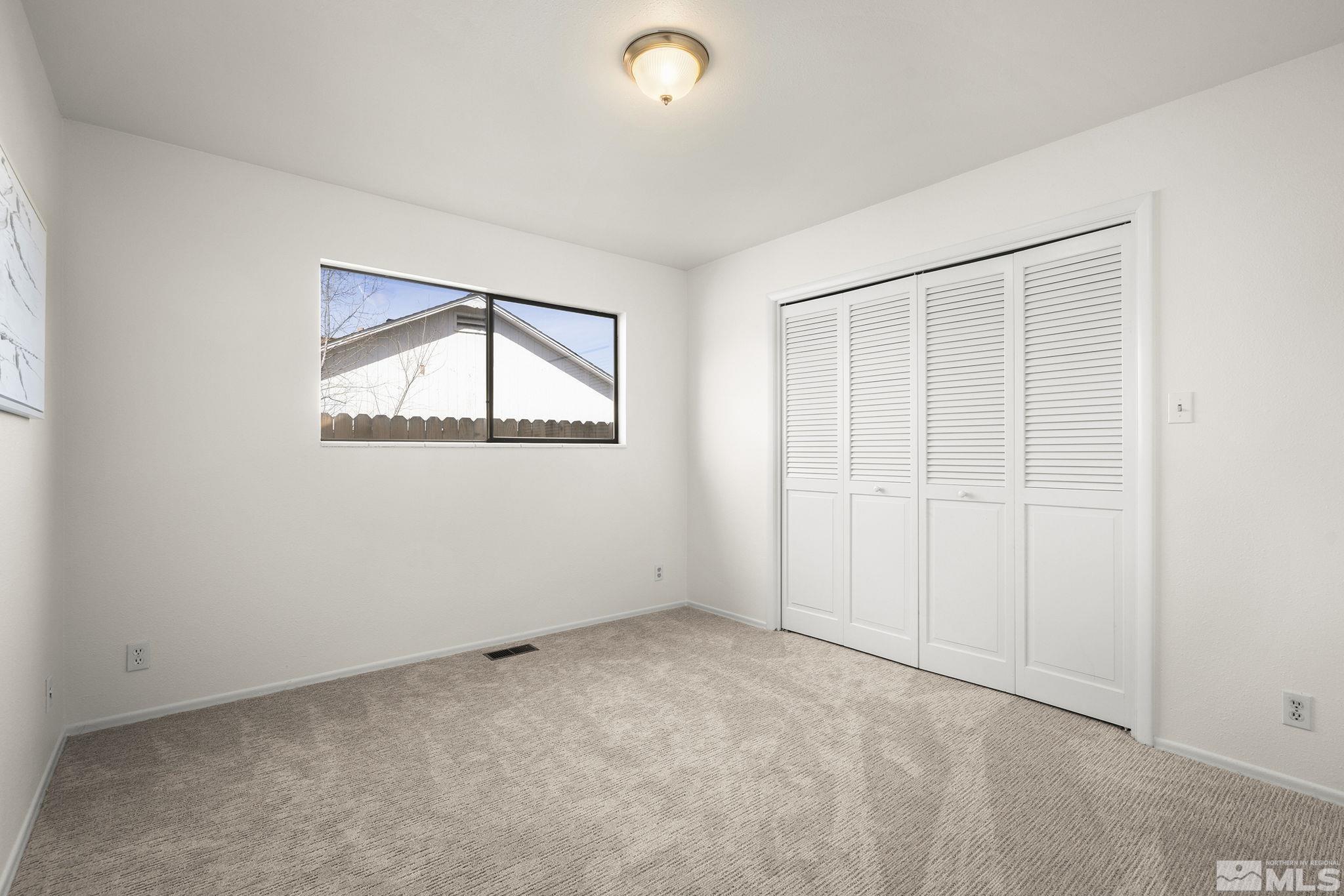 1680 Hunter Lake Drive Reno, NV 89509 - Photo 19 of 26 an empty room with a window