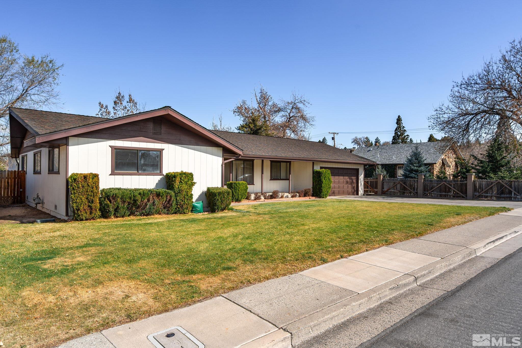 1680 Hunter Lake Drive Reno, NV 89509 - Photo 2 of 26 a front view of a house with a yard