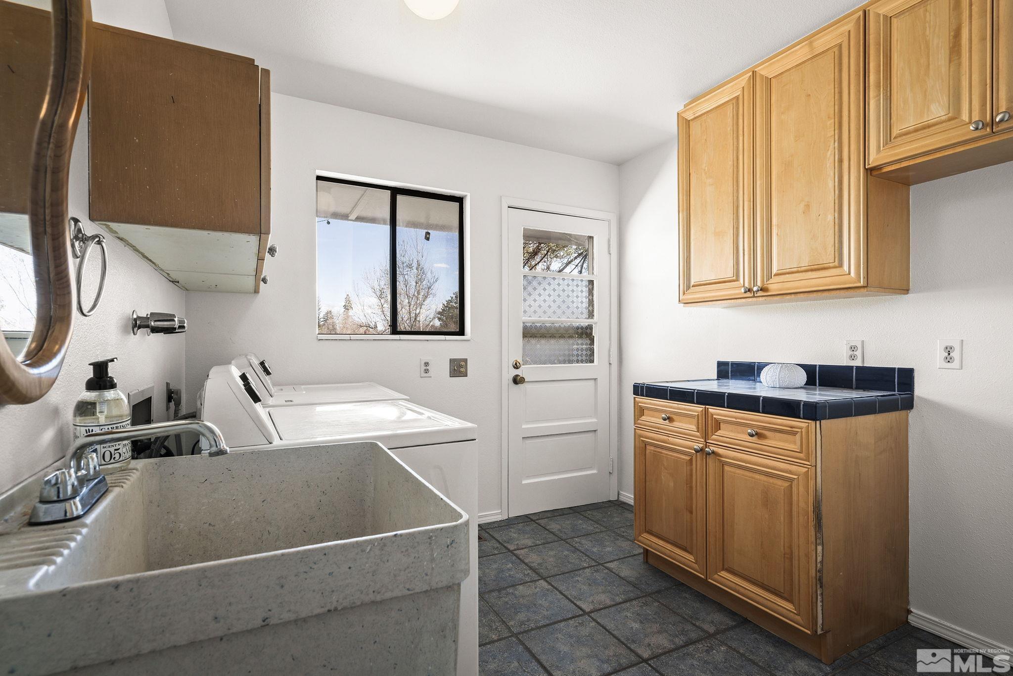 1680 Hunter Lake Drive Reno, NV 89509 - Photo 21 of 26 a kitchen with stainless steel appliances granite countertop a sink and a refrigerator