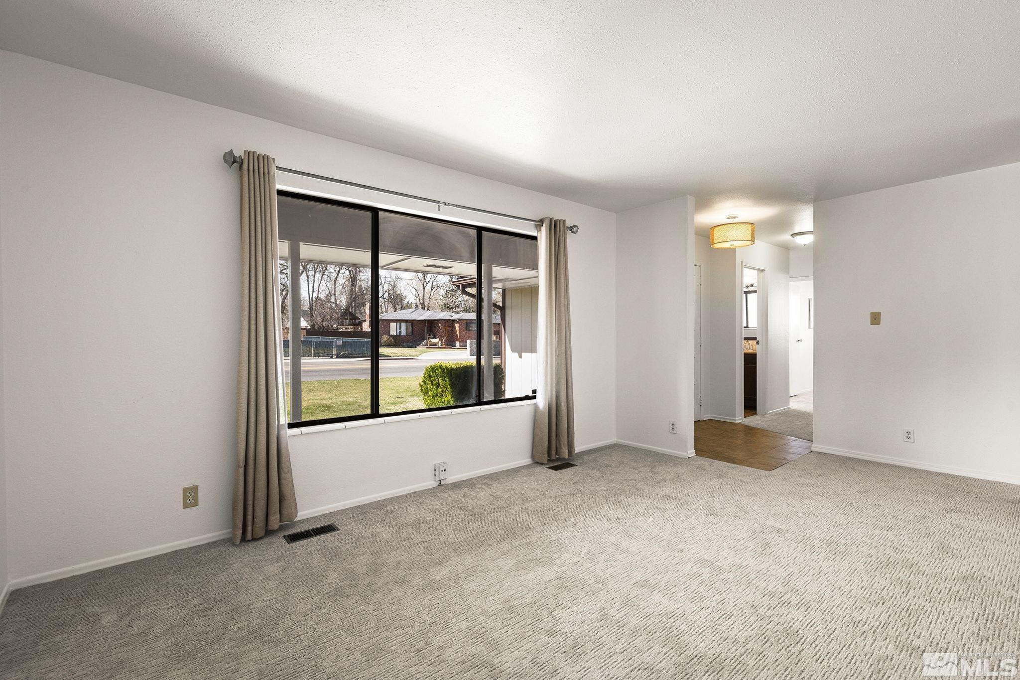 1680 Hunter Lake Drive Reno, NV 89509 - Photo 6 of 26 an empty room with floor to ceiling window