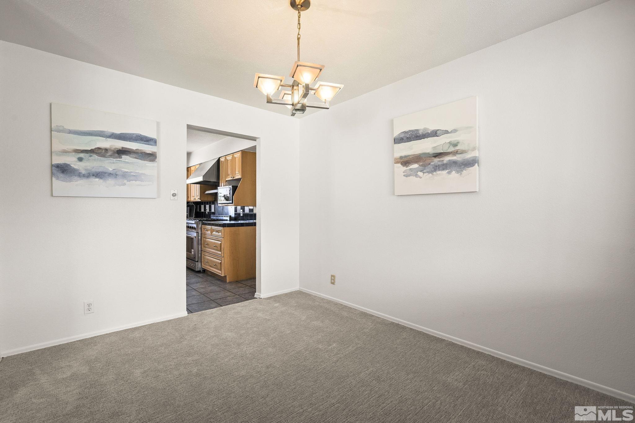 1680 Hunter Lake Drive Reno, NV 89509 - Photo 7 of 26 a view of a kitchen with a refrigerator a stove top oven and cabinets