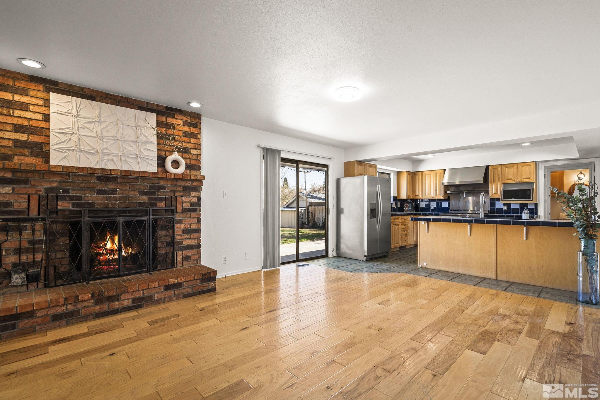 1680 Hunter Lake Drive Reno, NV 89509 - Photo 9 of 26 a view of a livingroom with fireplace kitchen view and windows