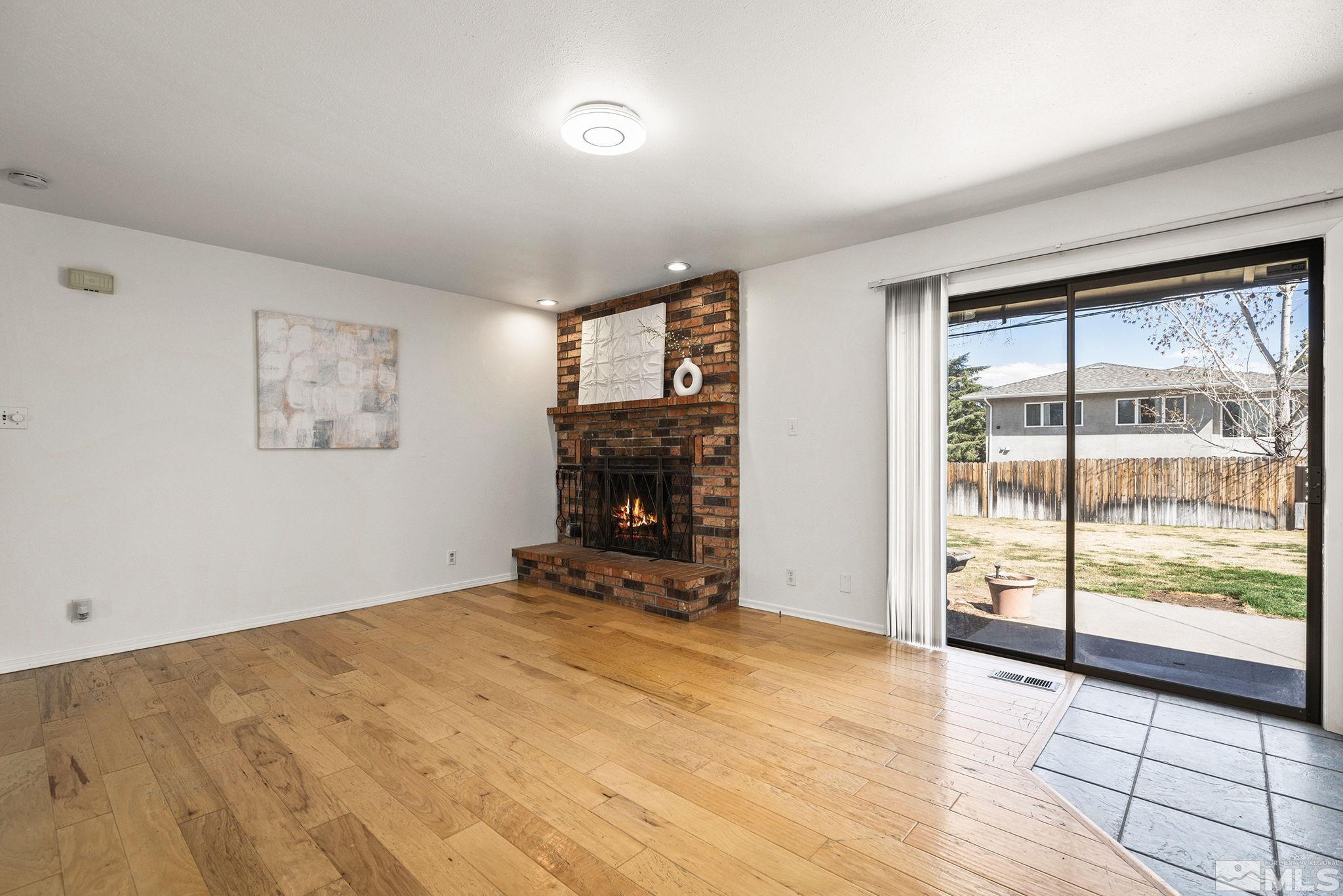 1680 Hunter Lake Drive Reno, NV 89509 - Photo 10 of 26 wooden floor in an empty room with a window