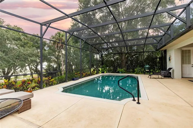 a dining room with furniture a chandelier and wooden floor