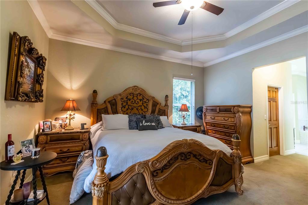 2329 South Lake Reedy Boulevard Frostproof, FL 33843 - Photo 23 of 86 a bedroom with bed and a chandelier