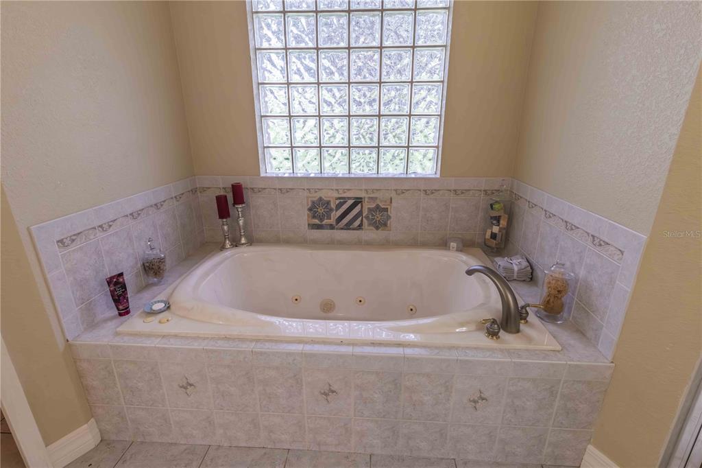 2329 South Lake Reedy Boulevard Frostproof, FL 33843 - Photo 26 of 86 a bath tub sitting in a bathroom next to a window